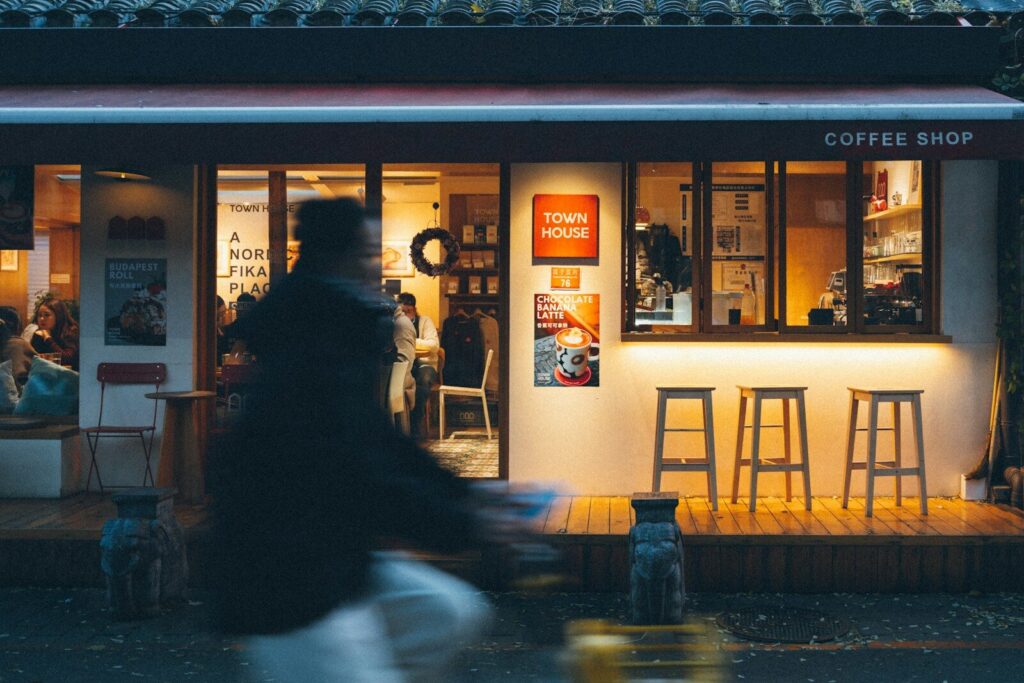 Coffee shop exterior with blurred person walking past