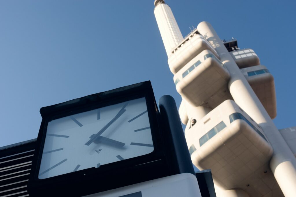 a clock tower next to a skyscraper
